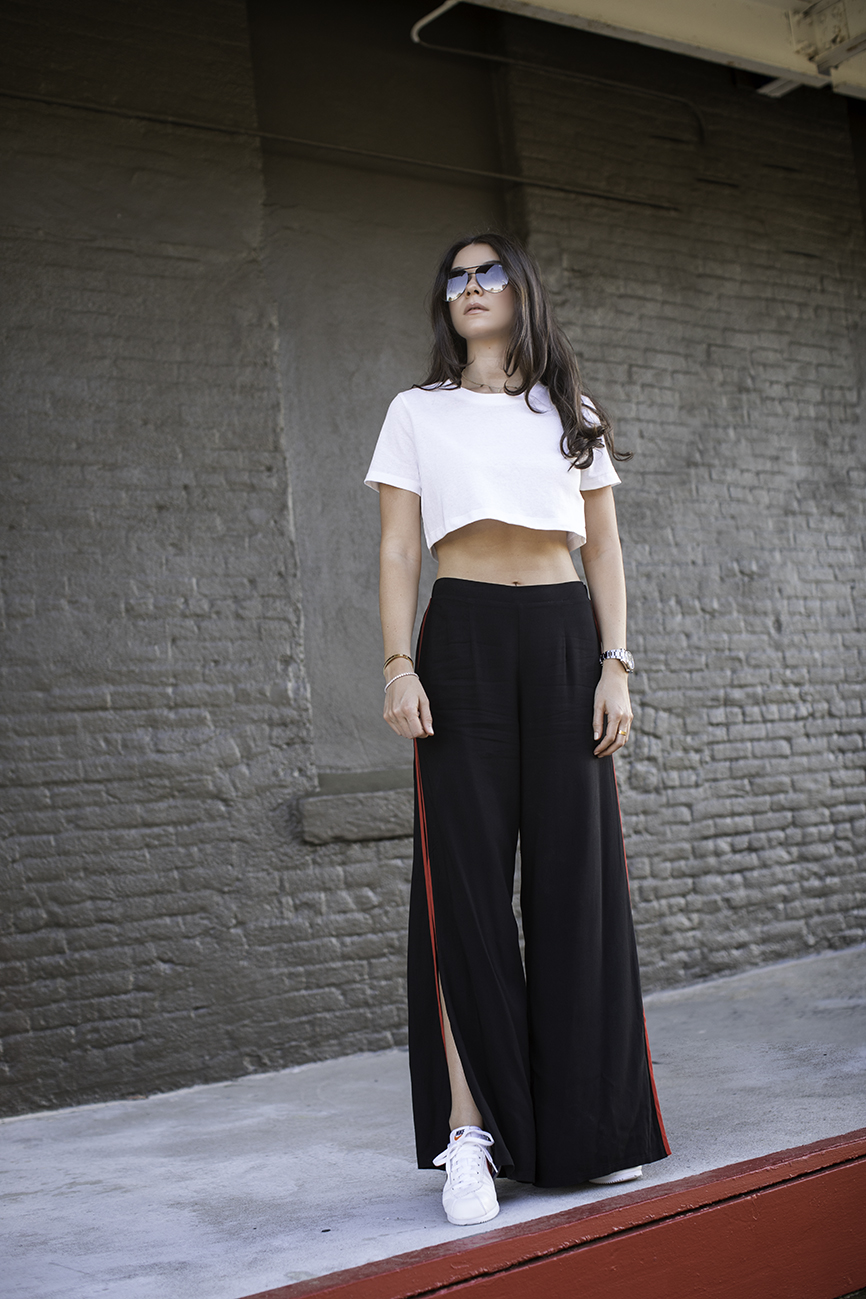 Liv wearing Nike Cortez, Forever 21 black red palazzo track pants, cropped t-shirt and quay sunglasses