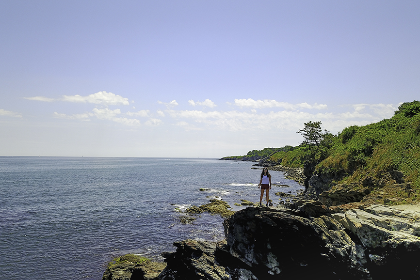 Liv on a rock paces off of the famous Cliff Walk in Newport Rhode Island over looking the beautiful First Beach Ocean
