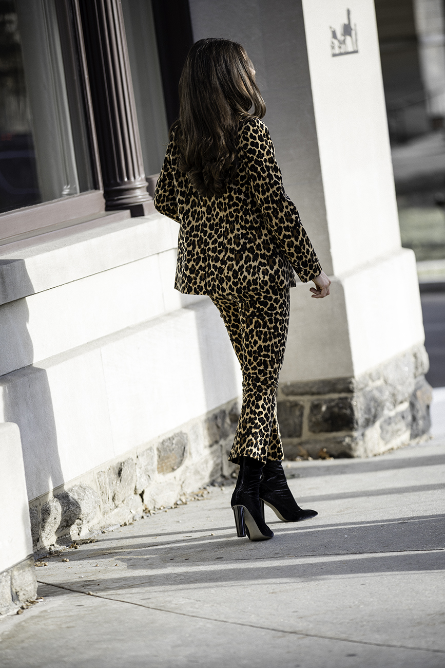 Liv Micheli is in Greenwich, CT wearing the Frame Cheetah Velveteen Classic Blazer, Frame Cheetah Velveteen Flare pants, Are You Am I Ling Top, Vintage Gold Mesh Belt from Etsy, and Public Desire Velvet boots. 