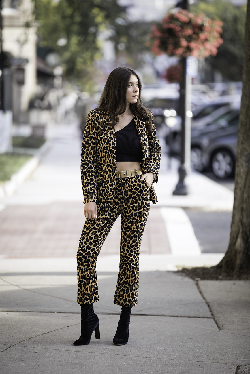 Liv Micheli is in Greenwich, CT wearing the Frame Cheetah Velveteen Classic Blazer, Frame Cheetah Velveteen Flare pants, Are You Am I Ling Top, Vintage Gold Mesh Belt from Etsy, and Public Desire Velvet boots. 