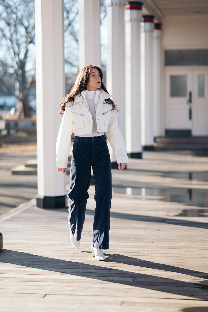 10 cropped jackets to ease you into spring liv for luxury liv micheli wearing polo Ralph Lauren corduroy pants, I.AM.GIA Icepere jacket, Wolford Colorado bodysuit and Stuart Weitzman white boots.
